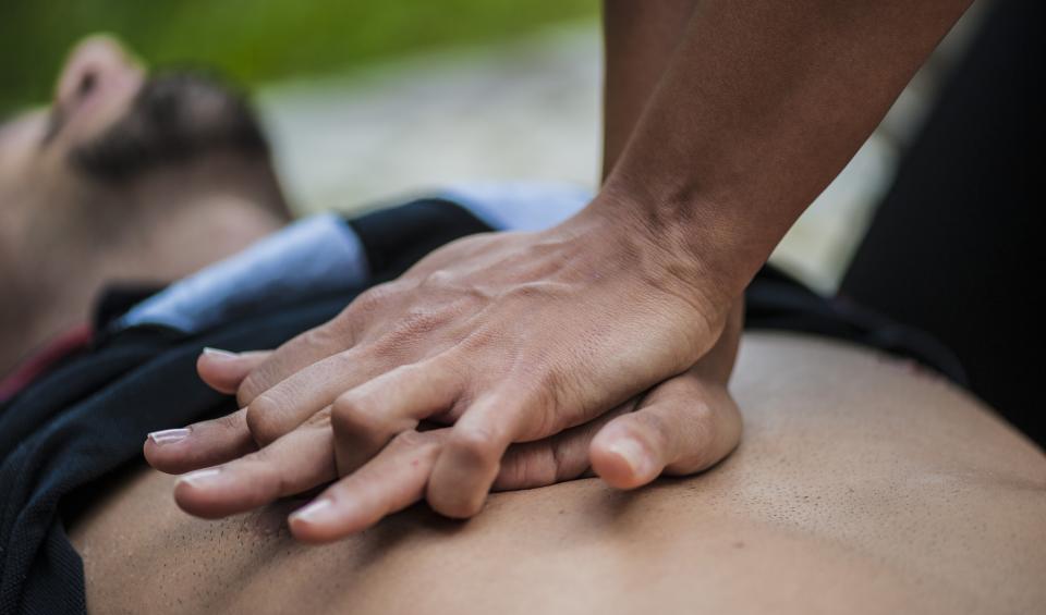 Man having CPR performed on chest.
