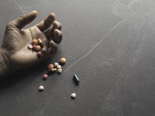 Hand with pills spilled