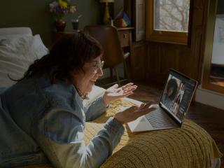 Woman on laptop smiling