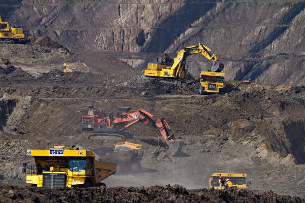 Mining trucks. Photo by Dominik Vanyi on Unsplash