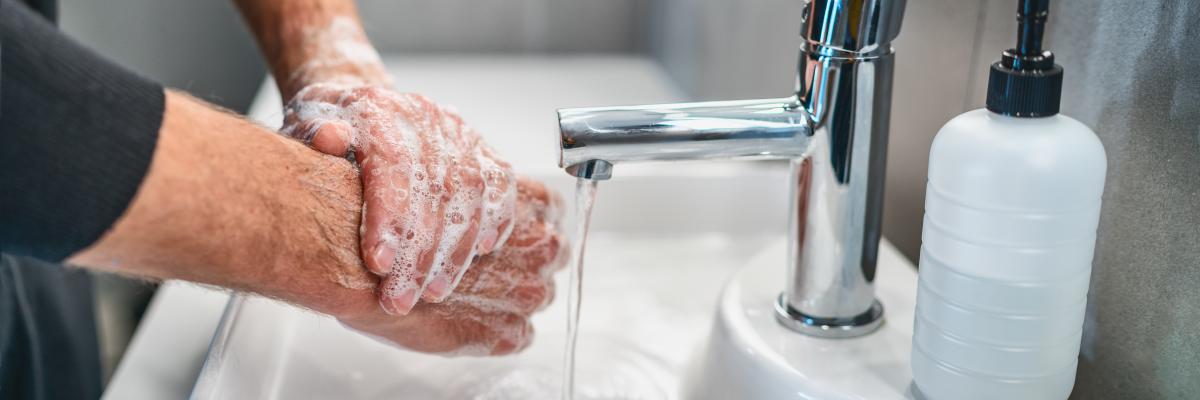 Man washing hands in sink